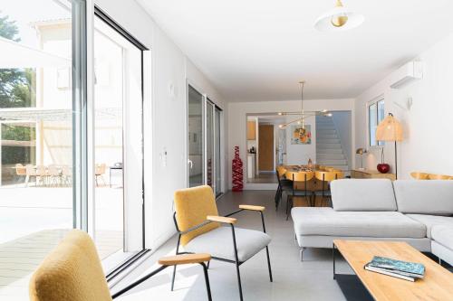 a living room with a couch and a table at Villa Acacias - Au coeur de Saint-Tropez in Saint-Tropez