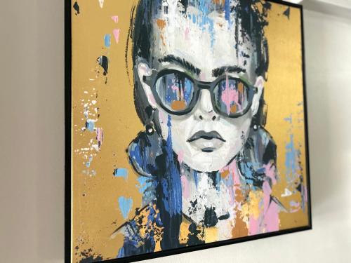 a painting of a woman with sunglasses on a wall at soho london suite in London