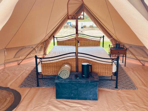 a bedroom in a tent with a bed in it at Bell Tent aan de haven in Heerewaarden