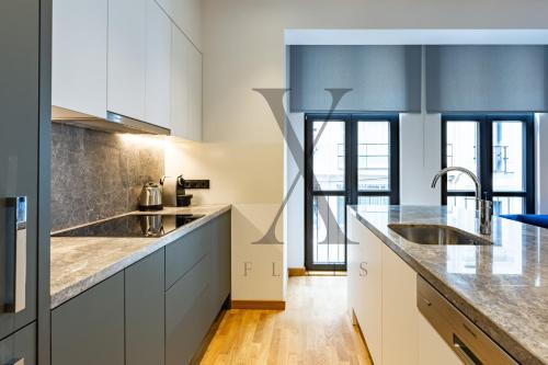 a kitchen with white cabinets and stainless steel appliances at X Flats in Istanbul
