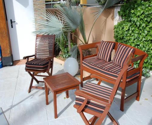 a group of chairs and a table on a patio at Hostal Mar y Huerta in Es Cana