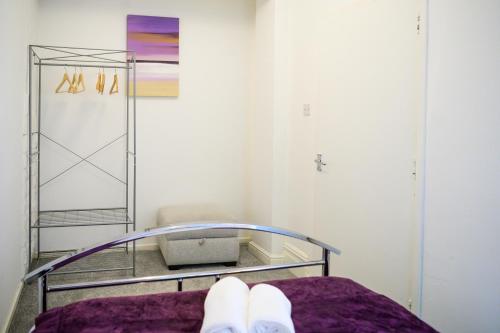 a persons feet on a bed in a room at Purple Blossom, 2 bed apartment, Wi-Fi, near Didsbury, free parking in Manchester