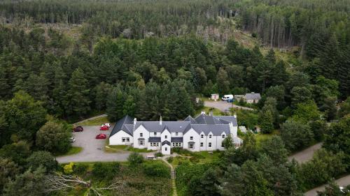 an aerial view of a large house in the woods at Cairngorm Lodge Youth Hostel in Loch Morlich