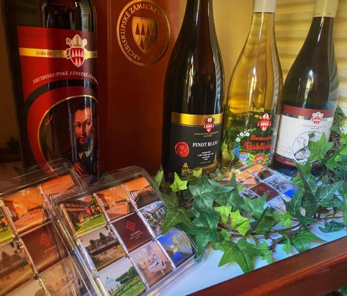 three bottles of wine sitting on top of a table at Hotel Octarna - Free On-site Parking in Kroměříž