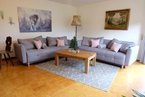 a living room with a couch and a table at SchwarzWild - Ferienwohnung und Ferienzimmer in Baiersbronn