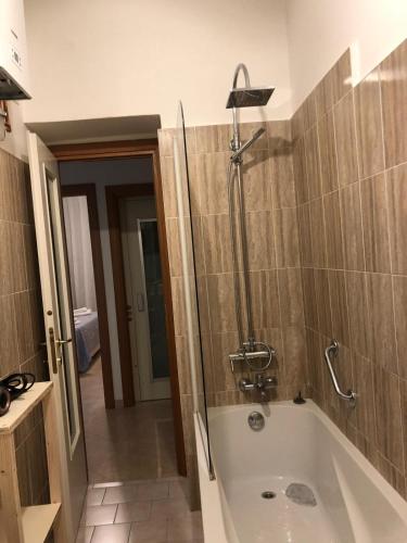 a bathroom with a bath tub and a shower at Manarola apartament in La Spezia
