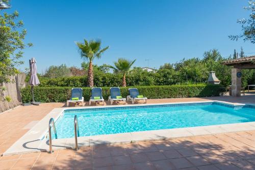 a swimming pool with lounge chairs next to at Ca Na Rosa in Campanet