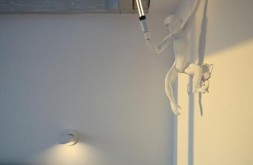 a wooden statue of a woman holding a bat at Oldwell Hotel in Santa Domenica