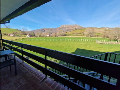 a balcony with a view of a field and mountains at Hostal Lizuniaga in Bera