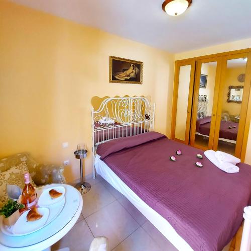 a bedroom with a bed and a table with food on it at SMALL APARTMENT, Adeje House Wifi Free in Adeje