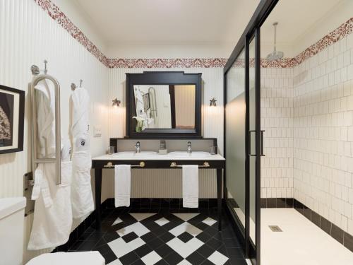a bathroom with a sink and a mirror at H10 Corregidor Boutique Hotel in Seville