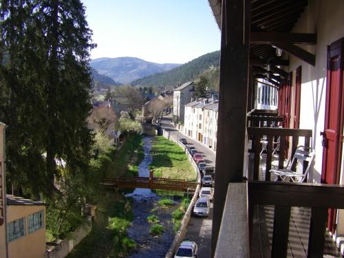 a view of a river from a balcony at Hotel De l'Europe in Meyrueis