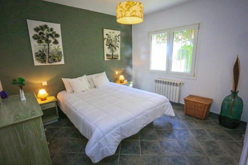 a bedroom with a large white bed and a window at Villa Monet ONLY FAMILIES in Cambrils