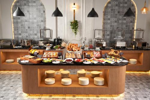 a buffet of food on a table in a restaurant at Mövenpick Samarkand in Samarkand