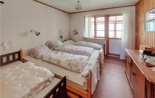 a bedroom with two beds and a window at Nice Home In Osby With Wifi in Osby
