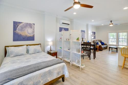 a bedroom with a bed and a living room at Coastal North Carolina Retreat - Walk to Beach! in Oak Island
