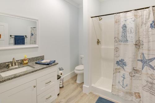 a bathroom with a toilet and a shower curtain at Coastal North Carolina Retreat - Walk to Beach! in Oak Island