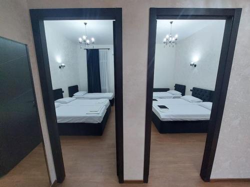 - deux miroirs dans une chambre avec deux lits dans l'établissement Soma, à Koutaïssi