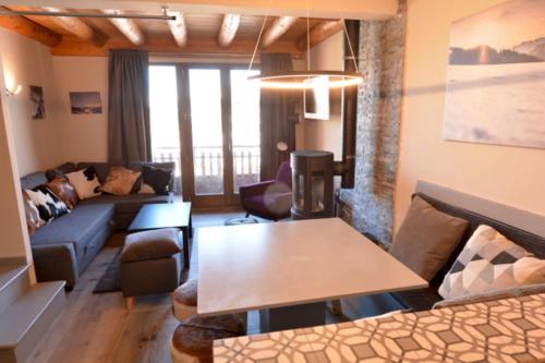 sala de estar con sofá y mesa en L'Aubépine 2 en Montalbert