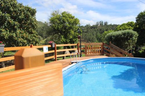 a small swimming pool with a wooden fence at Casa do Paço in Monção