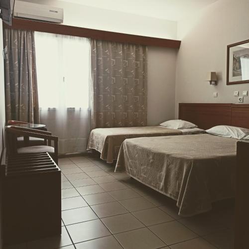 Ένα ή περισσότερα κρεβάτια σε δωμάτιο στο Hotel Solomou Athens