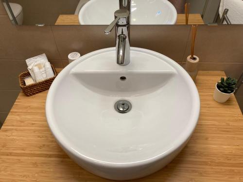 a white sink with a faucet in a bathroom at A Suata in Maratea