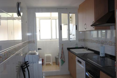 A kitchen or kitchenette at Delfines III Solo Familias Serviplaya