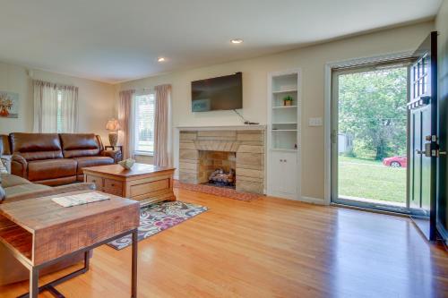 a living room with a couch and a fireplace at Home with Hot Tub and Deck about 3 Mi to Ark Encounter! in Williamstown