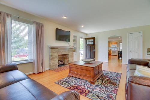 a living room with a couch and a fireplace at Home with Hot Tub and Deck about 3 Mi to Ark Encounter! in Williamstown