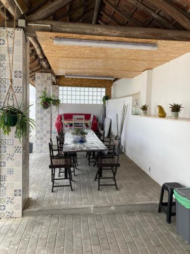 an outdoor patio with a table and chairs at Moradia Bispo in Aljubarrota