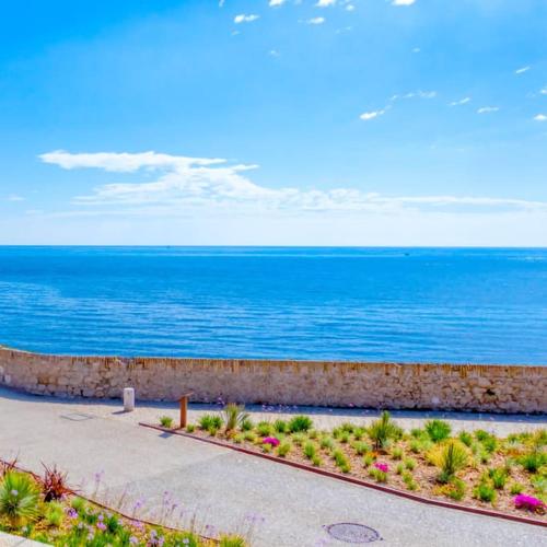 a walkway next to the ocean with the ocean at A9 - 1 BDR Fantastic Sea View Remparts Old Antibes - AC in Antibes