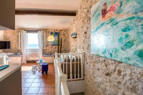 a living room with a painting on the wall at A9 - 1 BDR Fantastic Sea View Remparts Old Antibes - AC in Antibes
