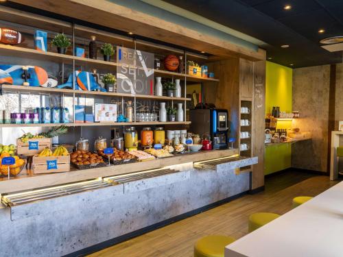 a restaurant with a counter with food on it at Ibis Budget Barcelona Viladecans in Viladecáns