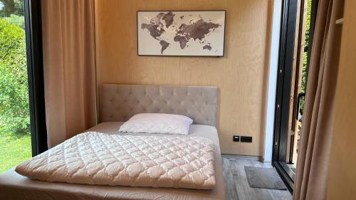 1 dormitorio con 1 cama con mapa en la pared en Luxusní apartmán v Praze Klánovicích na zahradě, 20 minut do centra Prahy, en Šestajovice