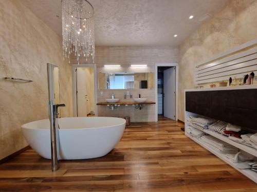 a bathroom with a large tub and a sink at Azalea Dreams by Santa Marija Estate in Mellieħa