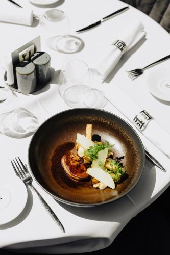 a table with a bowl of food on a table at Hôtel & Appartements Monsigny in Nice