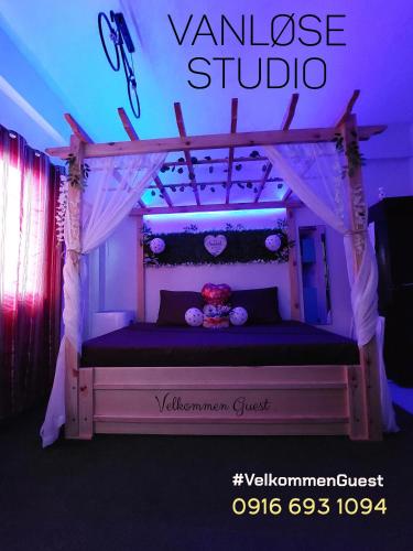 a bed in a room with a sign that reads valkyrie studio at NAIA Airport Vanløse Studio by Velkommen Guest PH in Manila
