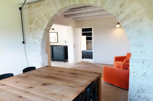 a living room with a wooden table and a couch at Villa Camarò in Favignana