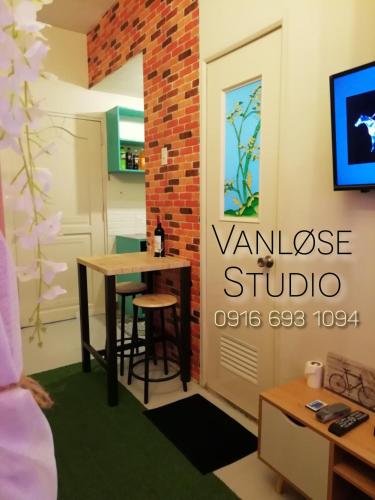 a room with a table and a sign that reads vance studio at NAIA Airport Vanløse Studio by Velkommen Guest PH in Manila
