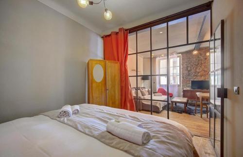 a bedroom with a bed and a living room at Red & Bleue YourHostHelper in Cannes