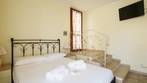 a bedroom with two beds and a flat screen tv at Welcomely - La Porta Sul Mare in Golfo Aranci