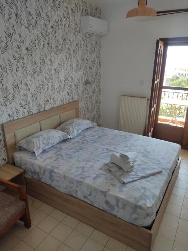 a bedroom with a bed with a teddy bear on it at House Mistral in Neos Marmaras