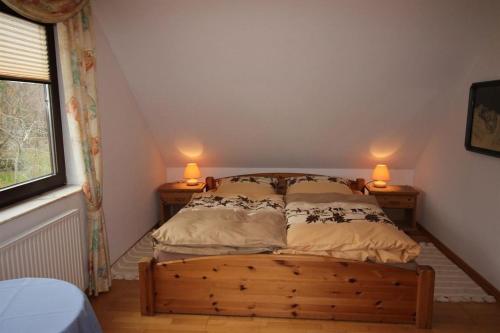 1 dormitorio con 1 cama con 2 lámparas en 2 mesas en Ferien am Waldesrand, en Lachendorf
