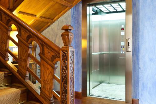 a staircase with a glass door in a house at La Casona del Viajante - Adults Only in Villabajo