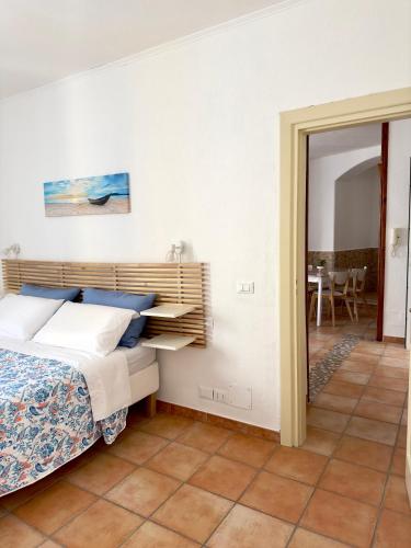 a bedroom with a bed with a wooden headboard at Dimora Saracena Forio in Forio d'Ischia