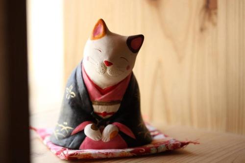a figurine of a cat sitting on a table at 帝塚山忍者屋敷 in Osaka