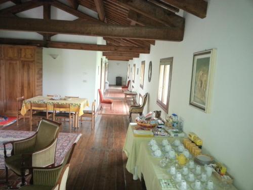 a living room with a table and a dining room at Villa Mainardi Agriturismo in Camino al Tagliamento