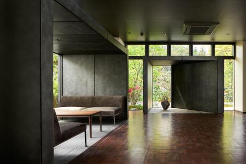 a living room with a table and two chairs at Ryokan Sumiya Kihoan in Kameoka