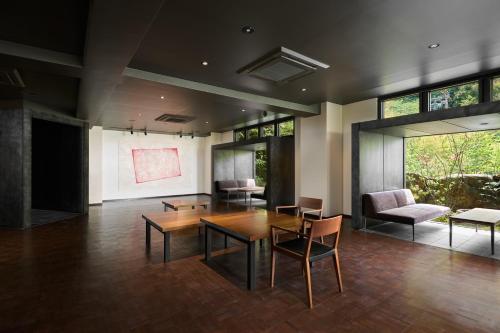 a large room with a table and chairs and a presentation at Ryokan Sumiya Kihoan in Kameoka