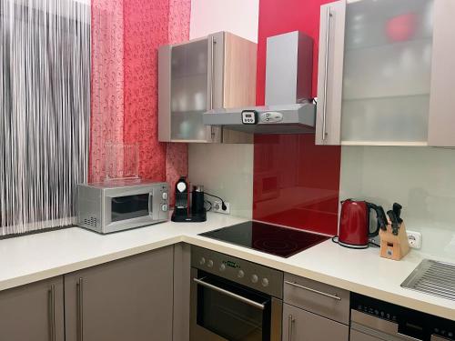 a kitchen with a stove top oven next to a microwave at Haus am Berg - Waldviertel in Arbesbach